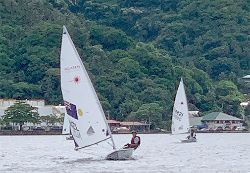 13-year old Junior sailor Carlos Leonel Sanchez of Utulei village leads into the first turn at the red buoy