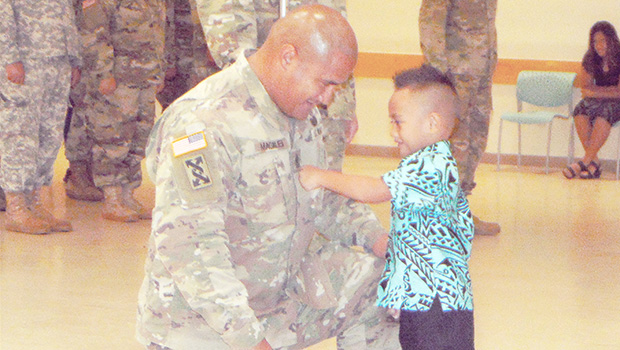 Newly pinned 1ST Sgt. Nathan Magalei of the 411th Engineer Battalion of the local U.S. Army Reserve and his son, Eisa Magalei, who had the honor of pinning his father