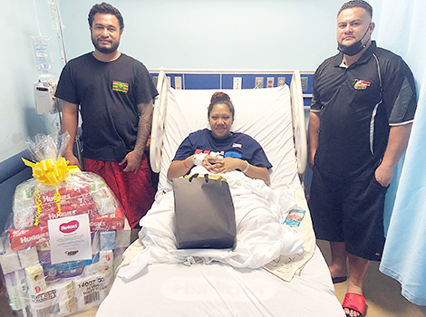 Faaleava Mack of Aasu receiving gifts