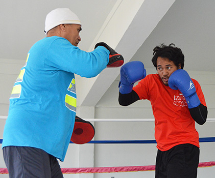 Trainer, Sala Senele Etuale hitting the pad with one of the local boxers 