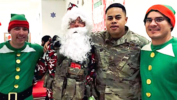 Senior Airman Oto with Santa and his elves