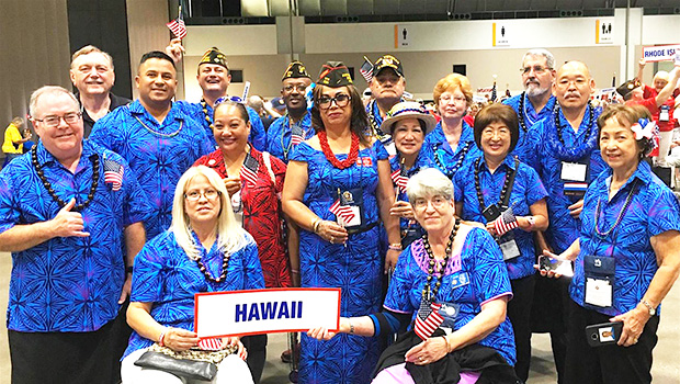Igafo Maria Brown Va’a (middle holding US flag with red lei) along with the Hawaii Veterans of Foreign War delegation