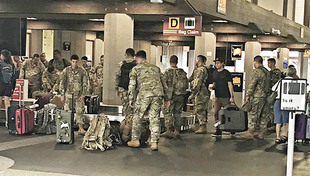 Some of American Samoa’s 100th Infantry Battalion 442nd Regiment picking up their luggage at the Hilo airport