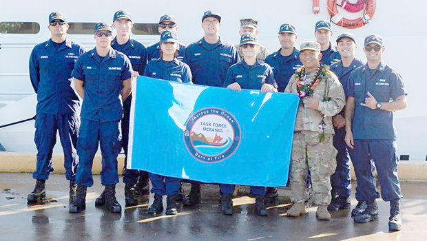 Maj. Julius Delapena pictured with crew members of the U.S. Coast Guard Cutter Oliver Berry