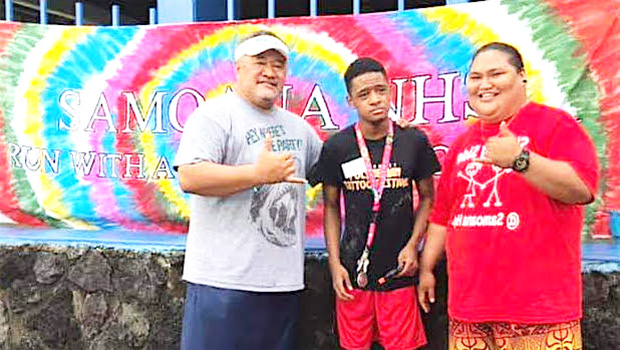 Samoana HS principal Rod Atafua with Special Education teacher Mafutaga Taase and SPED student DeAndre Chen