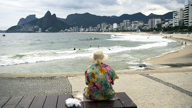An elderly woman watches Arpoador beach in Rio de Janeiro, Brazil, March 17, 2020