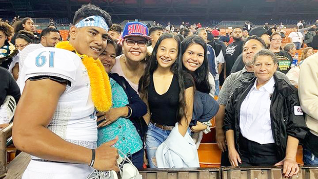 Belford Viali poses with family following