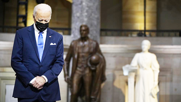 Pres. Joe Biden with head bowed 