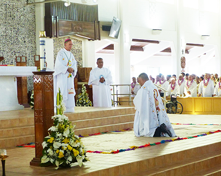 Bishop-elect Reverend Father Etuale kneels
