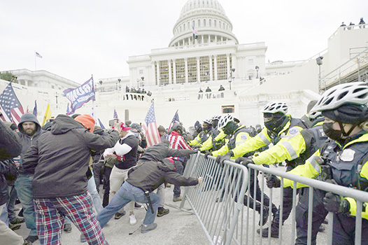 Trump supporters try to break through a police barrie