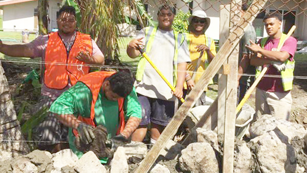 CJ Construction crew building a rock wall
