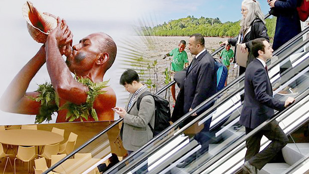  Visitors use an escalator past a poster featuring the Fiji Islands on the opening day of the COP 23 United Nations Climate Change Conference on November 6, 2017 in Bonn, Germany
