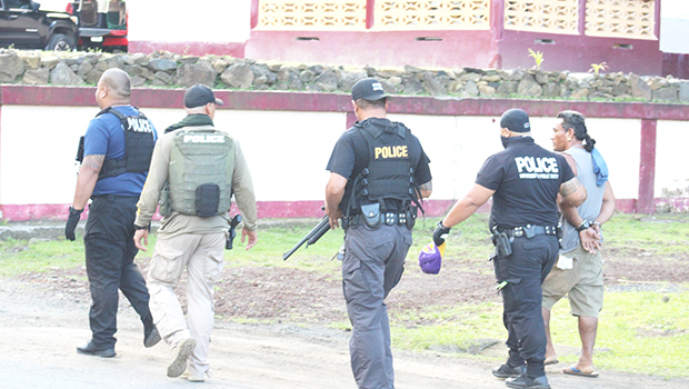 Police officers leading a suspect away 