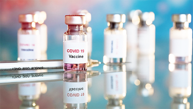 COVID vaccine viles and needle