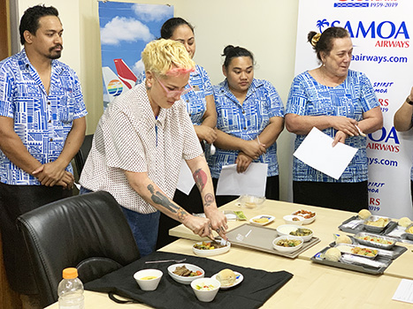 Samoa Airways staff members seeing samples of the airline’s new “farm to plane” menu