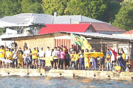 crowds of supporters lining the shoreline