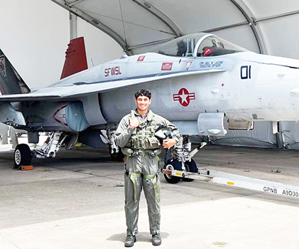 Daniel McMoore with a U.S. Navy fighter jet