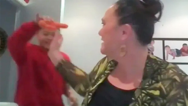 Son with carrot and mom trying to grab it