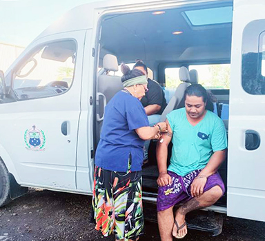 Nurse giving man a vaccination in the Public Health van