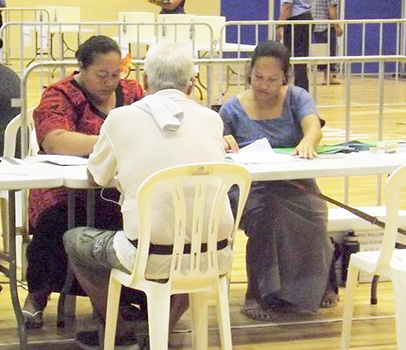 Two election officials and a voter