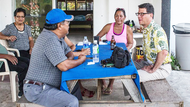 David Henkin (right) meets with Tinian residents 