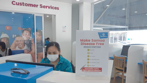 A woman working at Bluesky wearing a surgical face mask