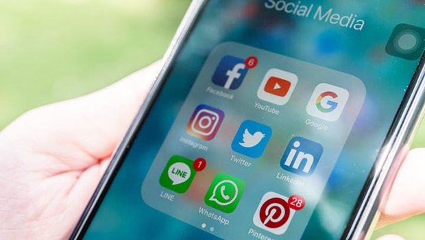 Social media apps, including Facebook, on face of smart phone