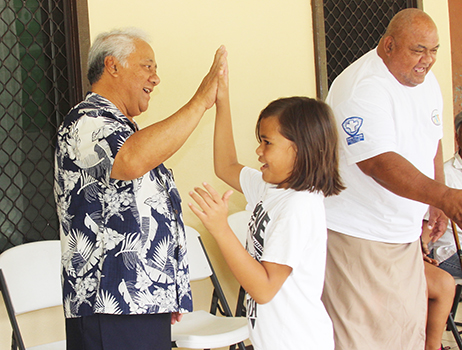 FFAS president, Sen. Faiivae Iuli Alex Godinet, high fives a player on