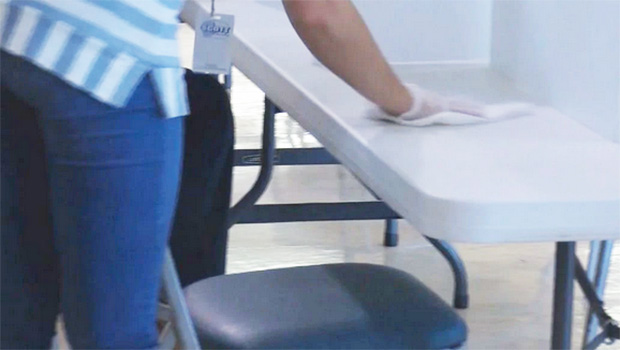 Woman cleaning off a table