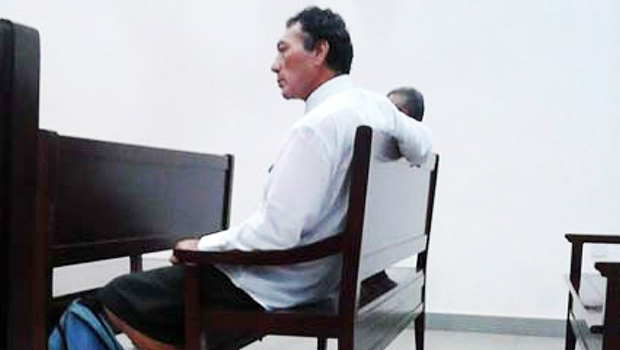 Father and son sitting in the courtroom