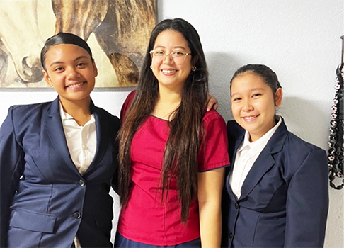 Talalelei Roberts (left) and Princess Viesca (right) joined by their HOSA advisor, Ms Cassandra Garcia (middle). 