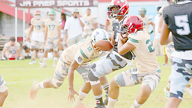 Scott Pese is brought down by two Team Fealofani defenders