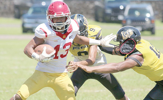 Tafuna’s ball carrier trying to evade the pressure from two Nu’uuli Wildcat defenders