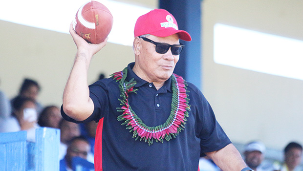 Gov. Lolo Matalasi Moliga passing football to open 2018 ASHSAA season