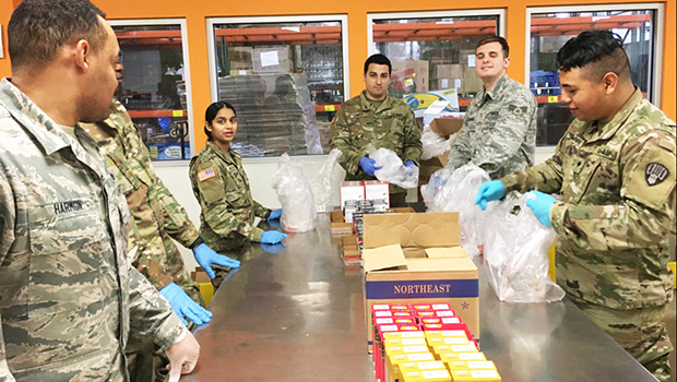 New York Army and Air National Guardsmen pack food parcels at Feeding Westchester, a food pantry in Westchester County, N.Y.