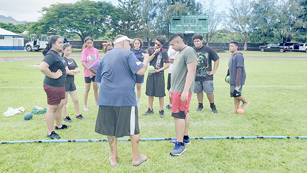 Coach CJ Sagapolutele Floor instructing Pacific Horizons School students