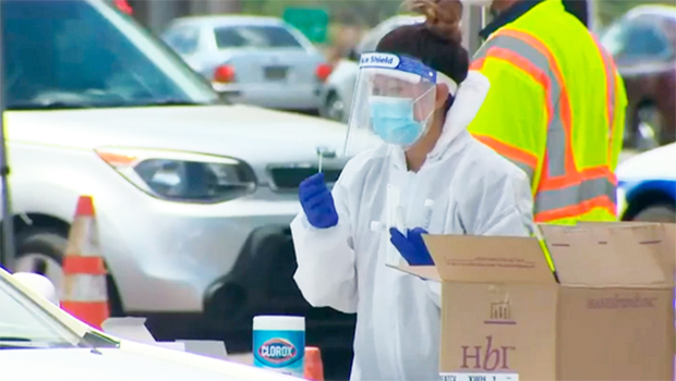 Surge testing site on Oahu where medical personnel are beside a car