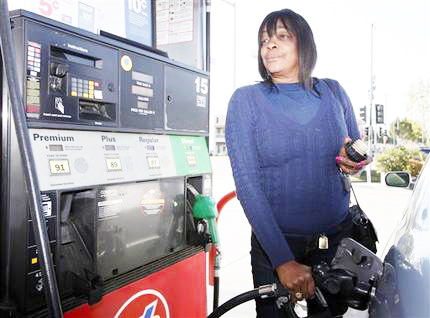 woman pumping gasoline into her car
