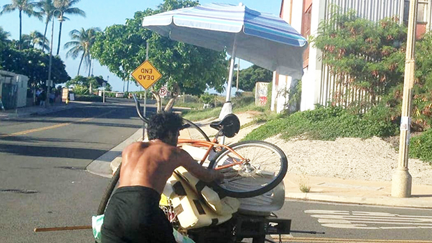 homeless man with bicycle and sunbrella