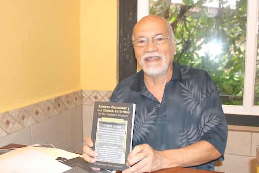 Author Fuimaono Fini Aitaoto holds a copy of his new book
