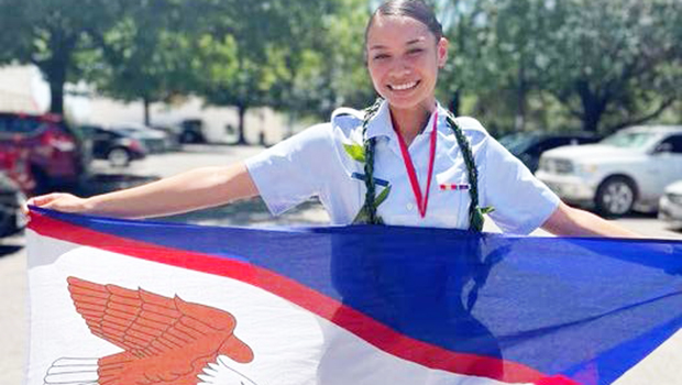 Joanya Tafua holding the American Samoa flag