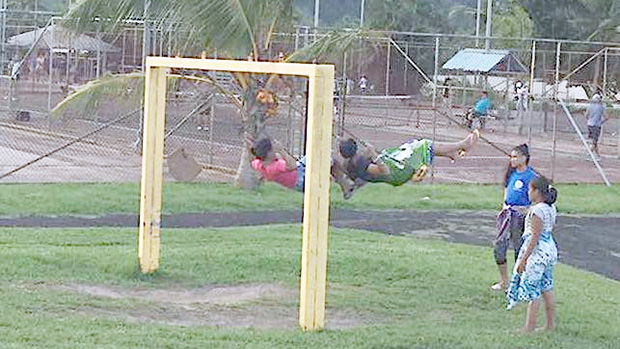 Children swinging on playground equipment at Lions Park