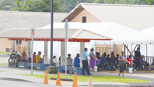People waiting in the LBJ emergency room triage tents