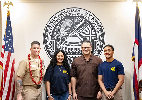 U. S. Navy Commander Robert L. Moran (left) and Lt. Gov Talauega E. V Ale with two young American Samoans 