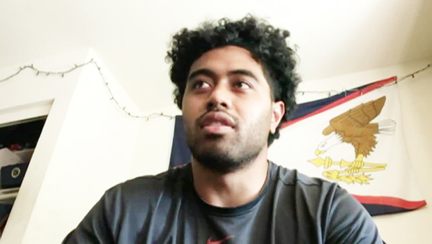 Vavae Malepeai with an American Samoa flag in the background