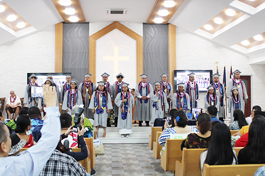 The fourteen graduates of Manumalo Academy 