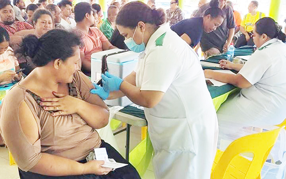 Women receiving vaccine in her arm
