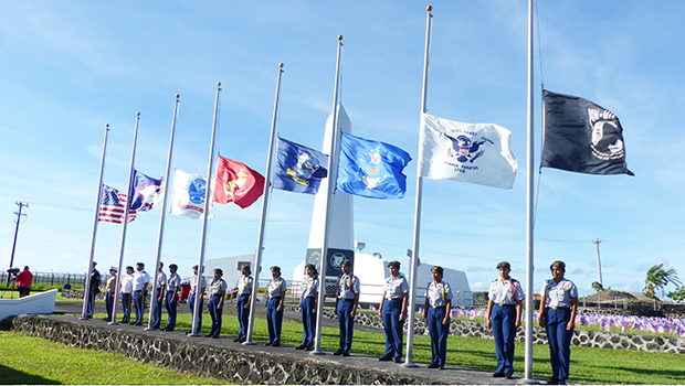 U.S.and American Samoa flags along with flags of the services at half staff