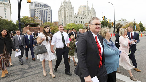 People arrive for the twice-annual conference of The Church of Jesus Christ of Latter-day Saints Saturday, Oct. 6, 2018, in Salt Lake City