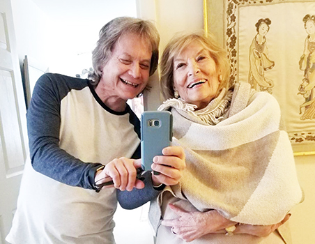 Leland Stein, left, takes a photo with his mother Sondra Green